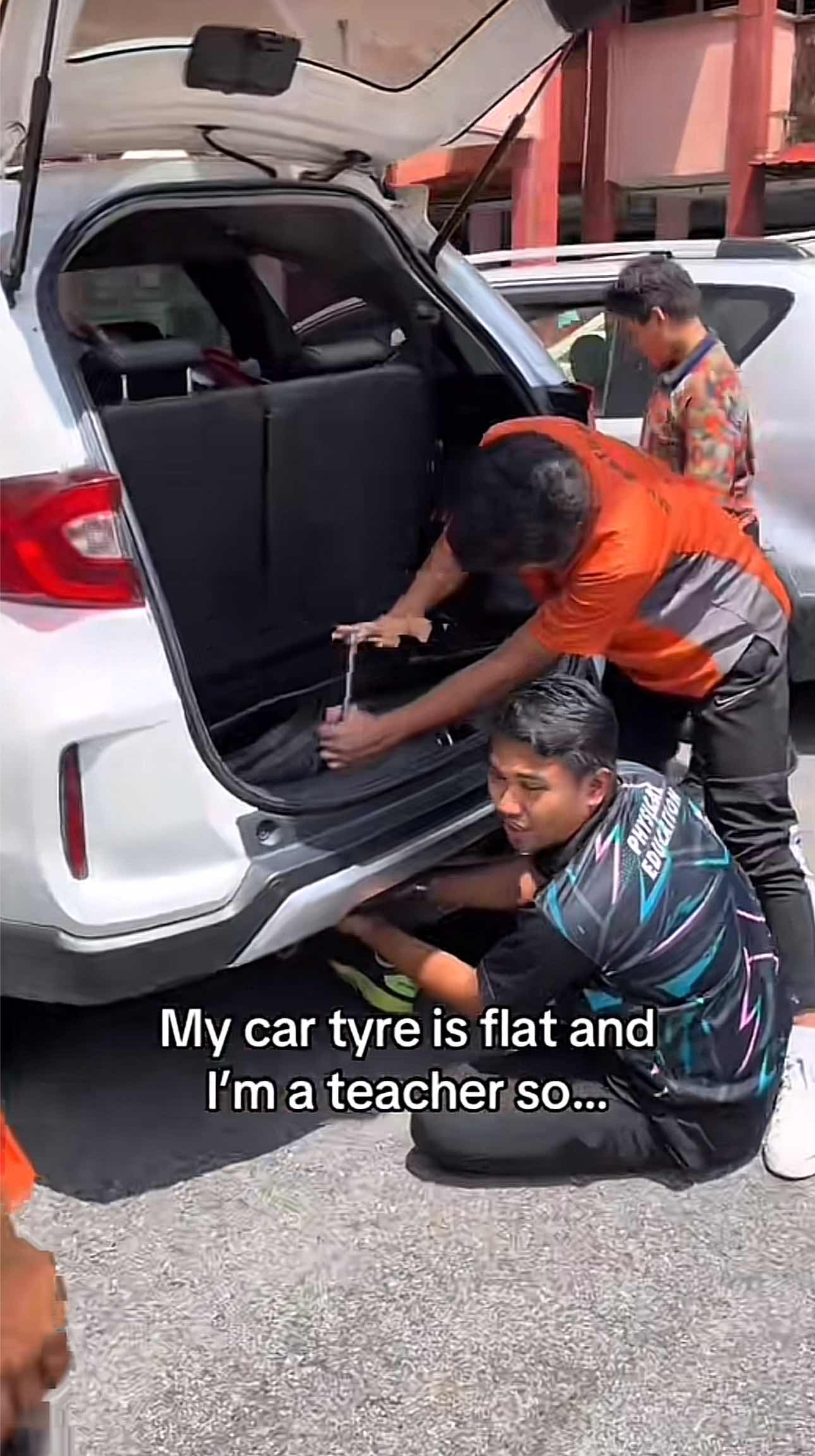Friends helping out each other to fix teacher's car
