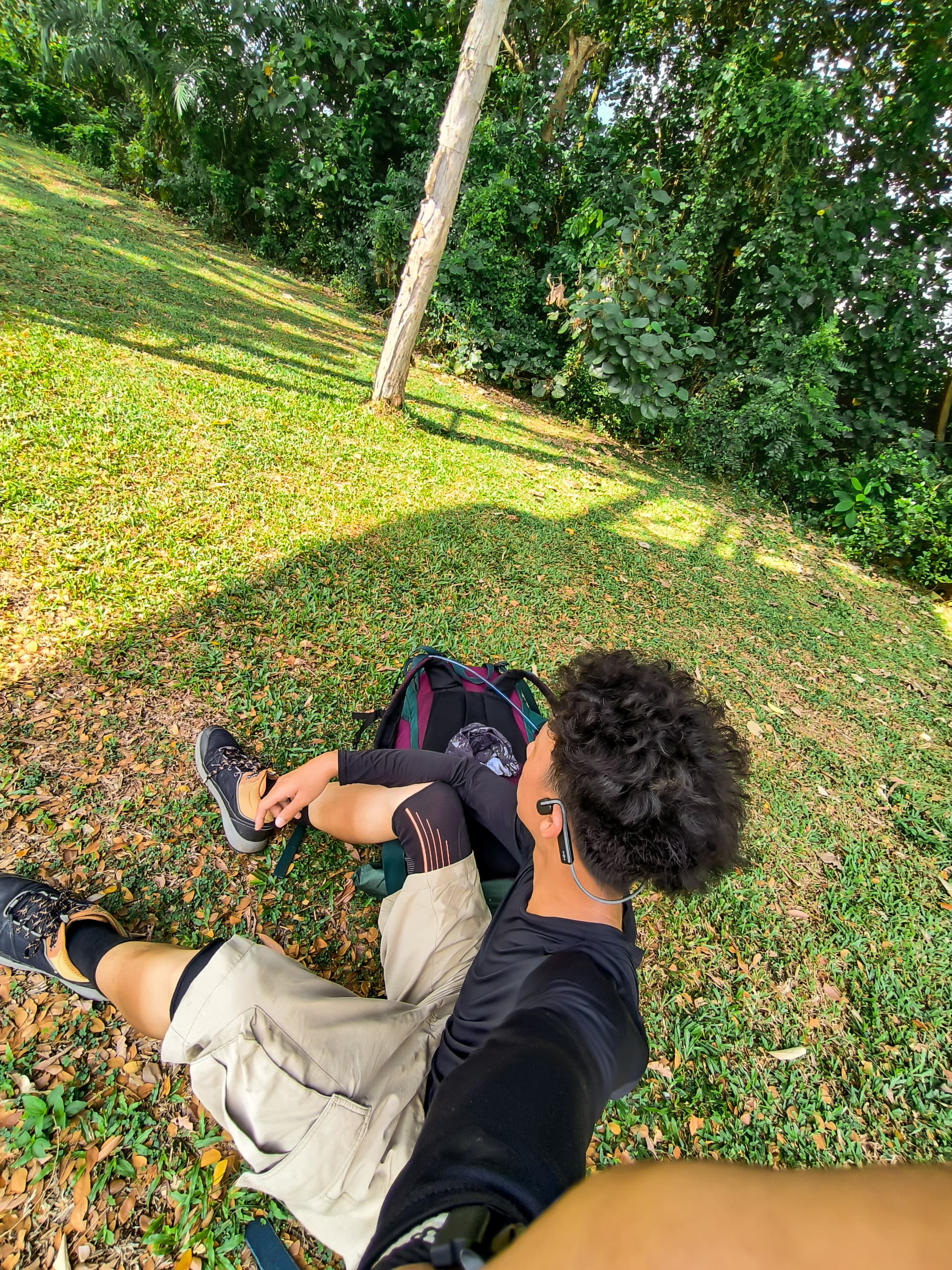 Nate sitting near the trees