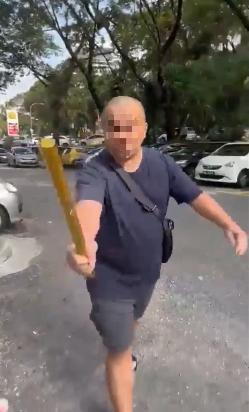 Bald malaysian man holding a metal rod