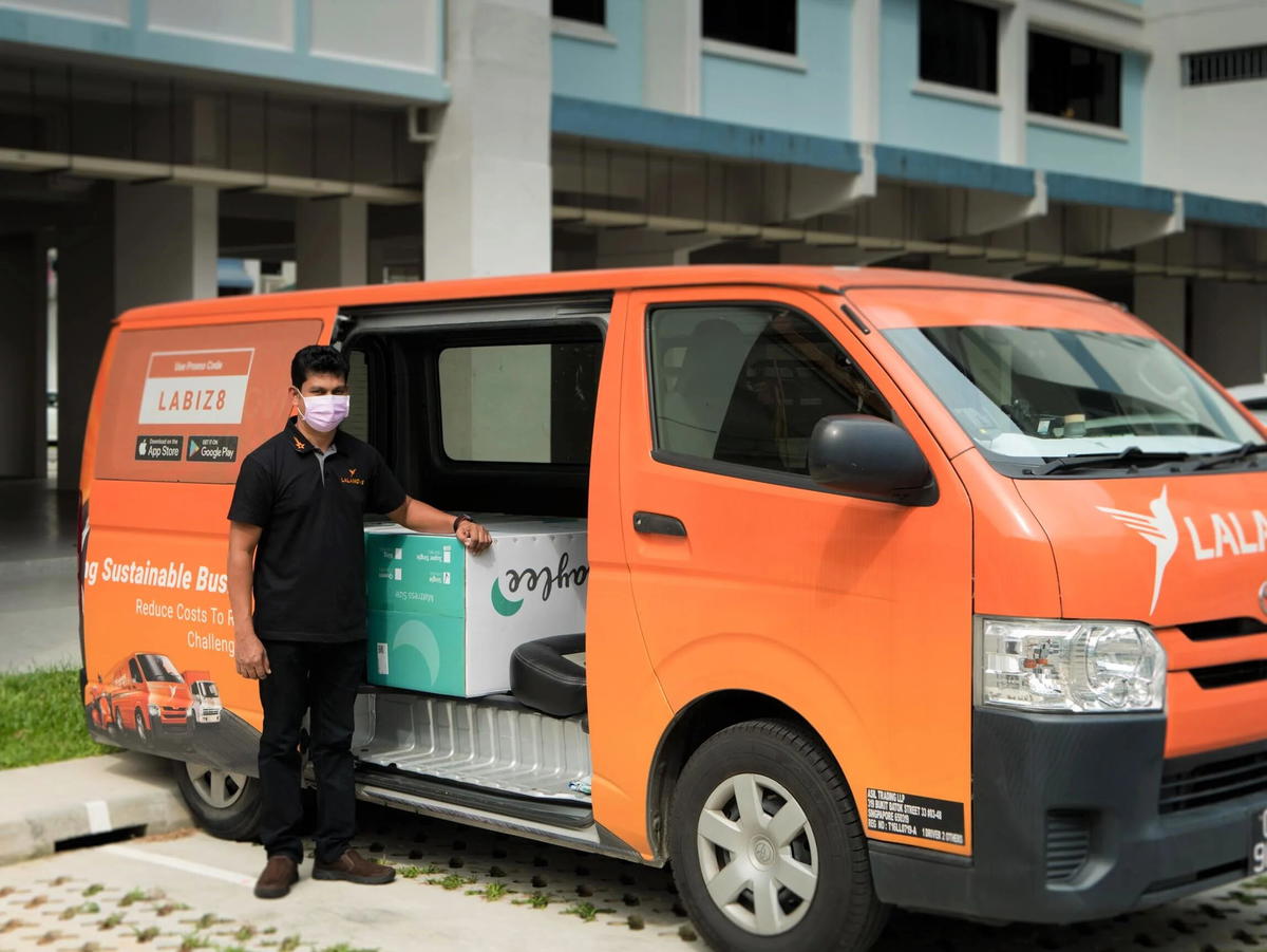 lalamove rider standing beside his van