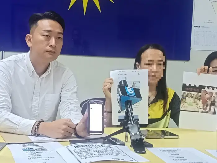 Lau speaking at press conference