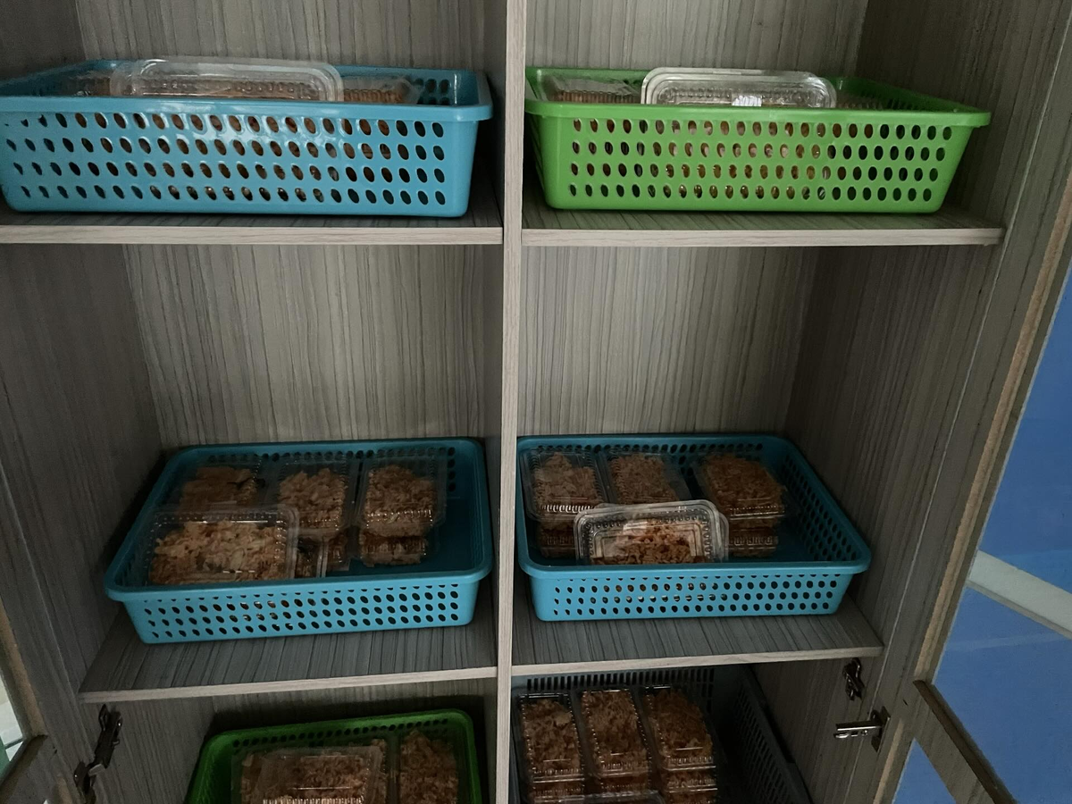 Lecturer puts food in cupboard 1