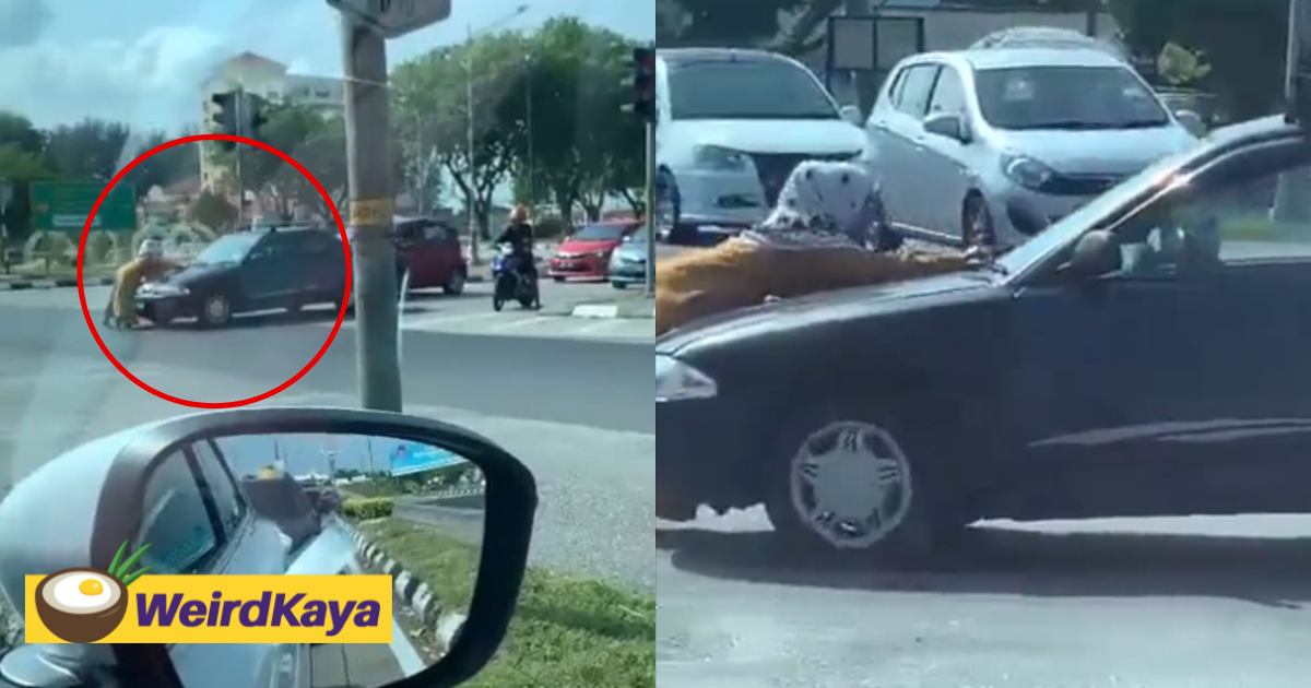 M'sian woman spotted trying to block moving car near traffic light in viral video | weirdkaya