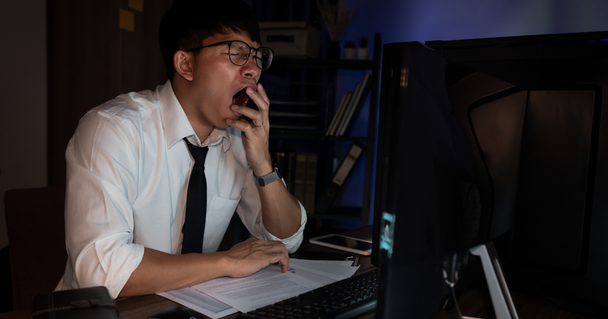 Man in office attire yawning