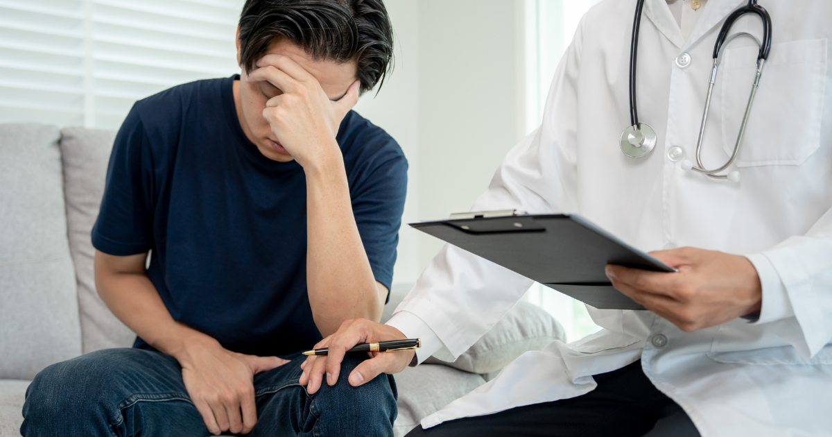 Man looks stressed with doctor consoling him