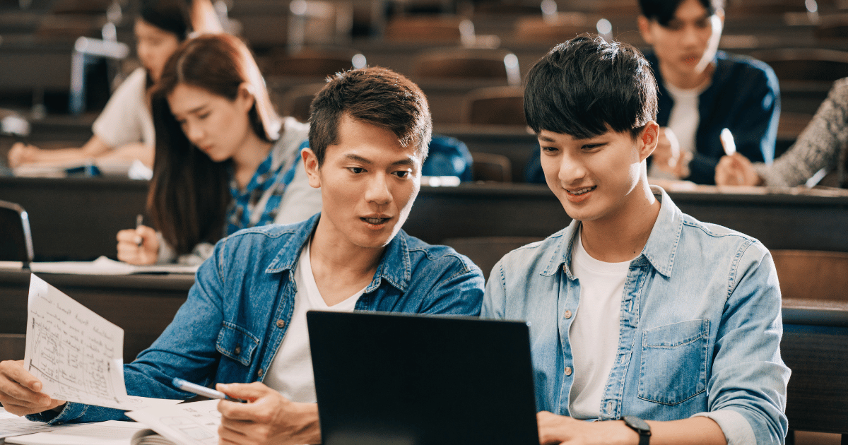 Two asian men studying using their laptop