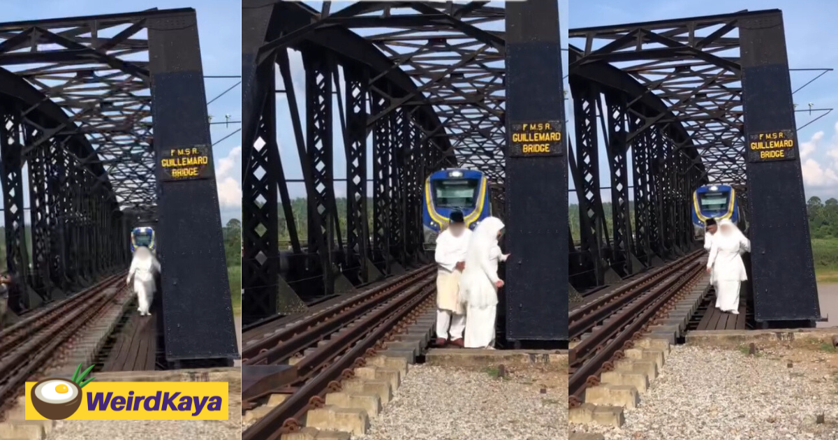 M'sian couple blocks ktm train's path during photoshoot at guillemard bridge in kelantan | weirdkaya