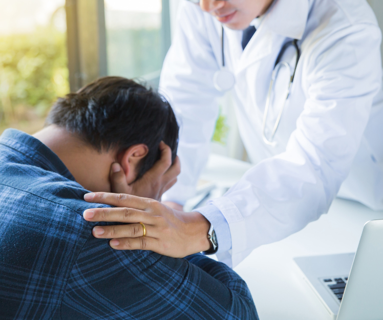 Patient consoled by doctor