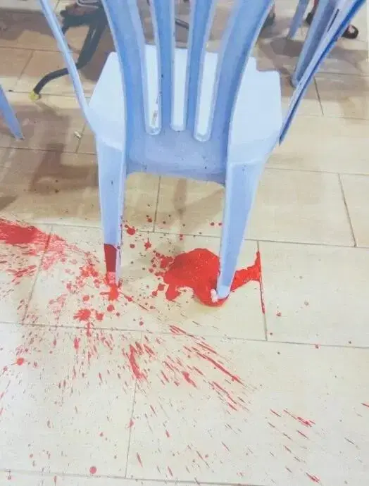 Liu's chair at home stained with red paint