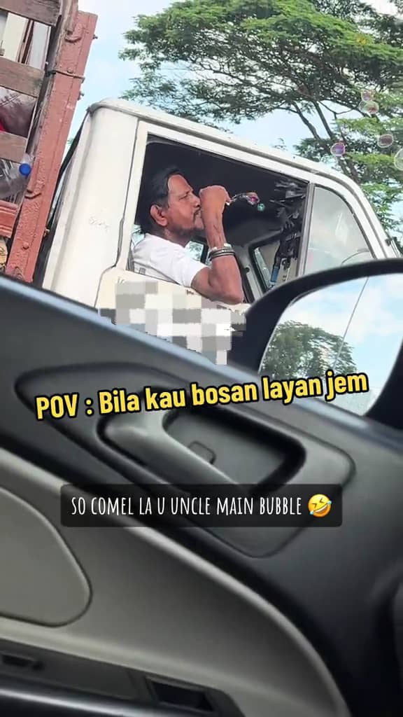 Lorry driver playng bubble toy in traffic jam