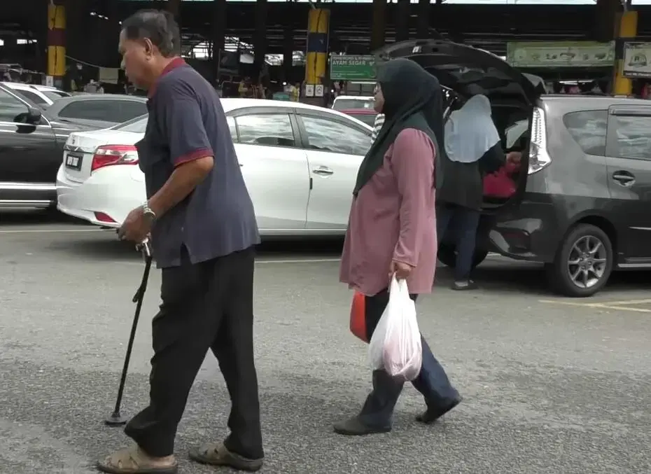 Mahazina helping customers with goods