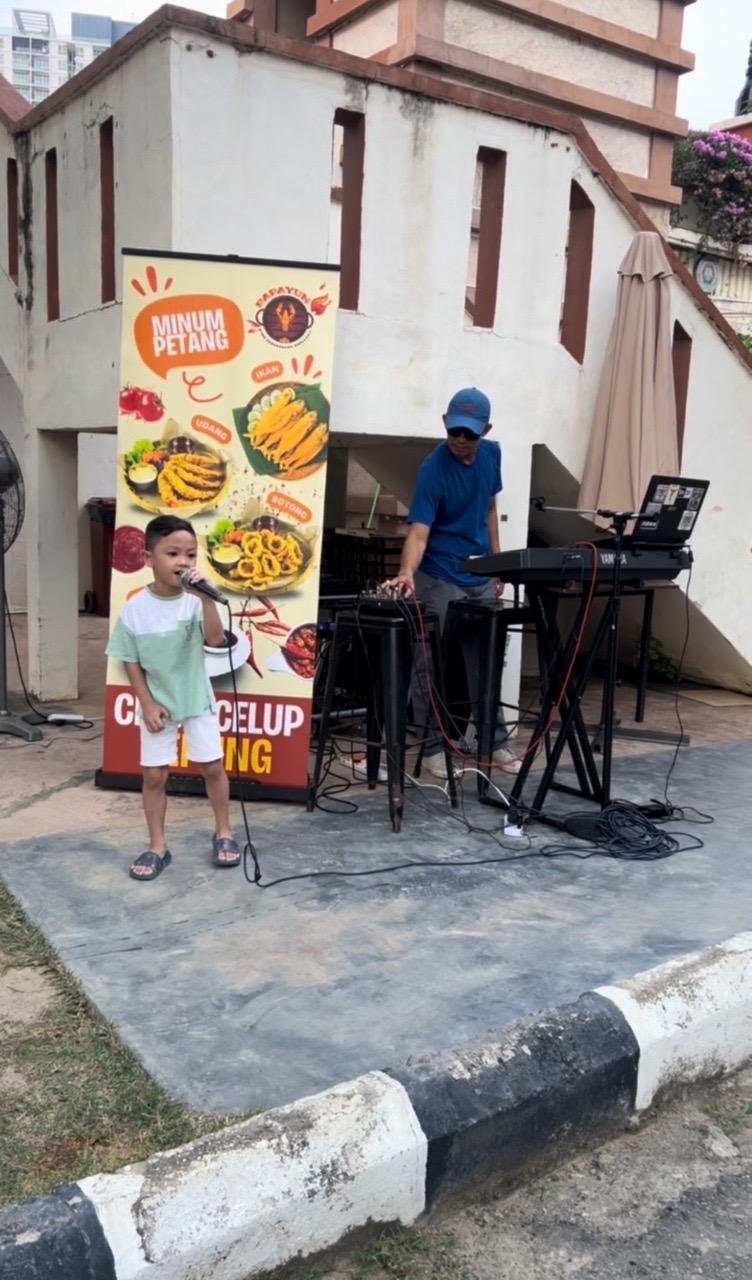 Malay boy singing zubir kahn song at restuarant