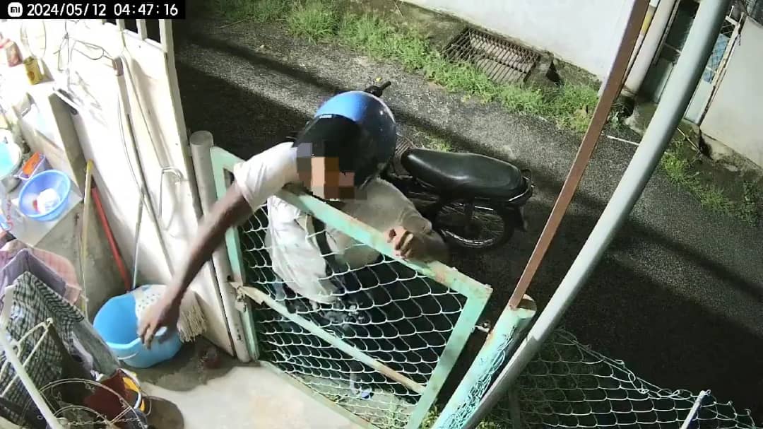 Man climbing gate to steal underwear