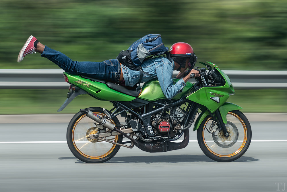 Man doing superman stunt on motorbike