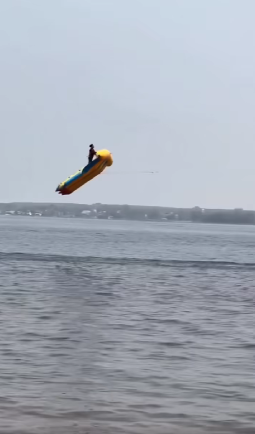 Man flying in the air with triple inflatable banana boat