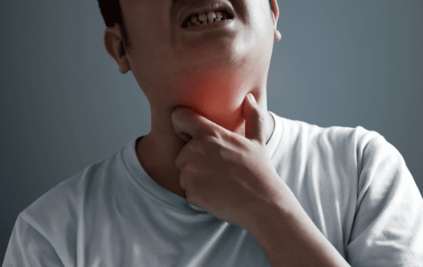 man having throat pains