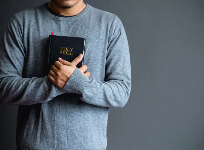 man holding Bible