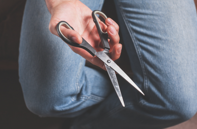 Man holding a pair of scissors