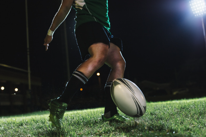 A man playing rugby in the field