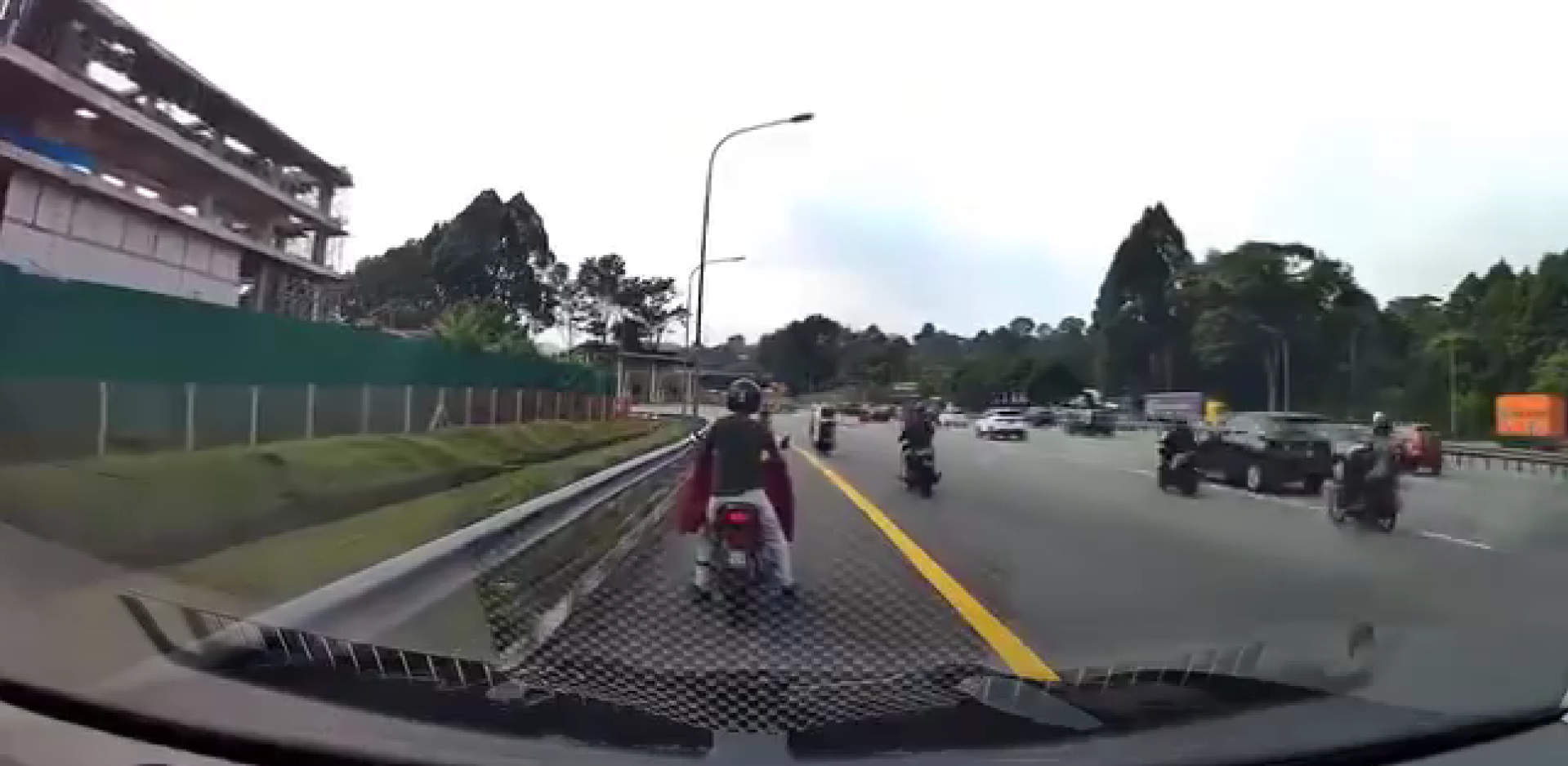 Man pushing his motorbike on road