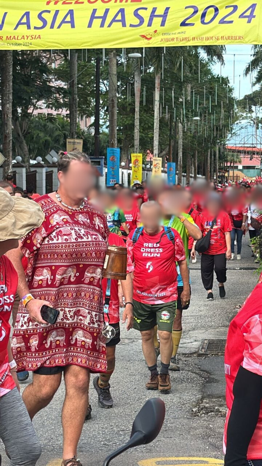 Man running in red dress at  pan asia international run