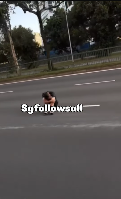 Man sits in the middle of road in s'pore