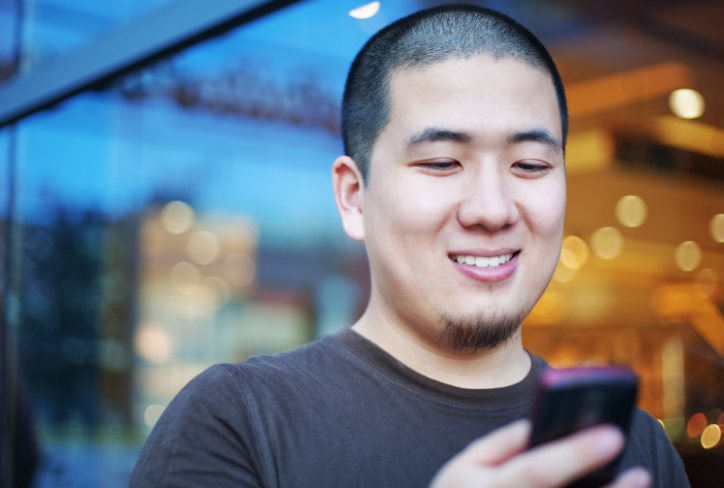 Man smiling looking at his phone