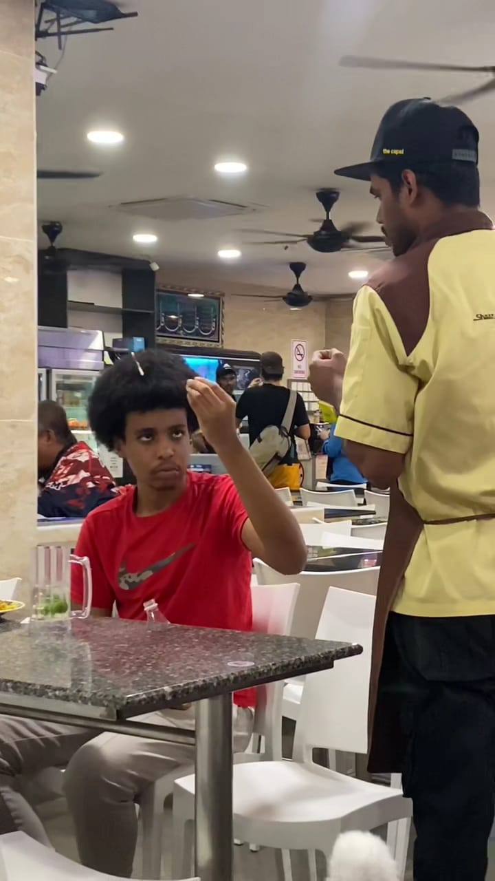 Man taking straw from his hair