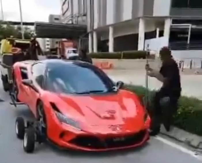 Man towing ferrari