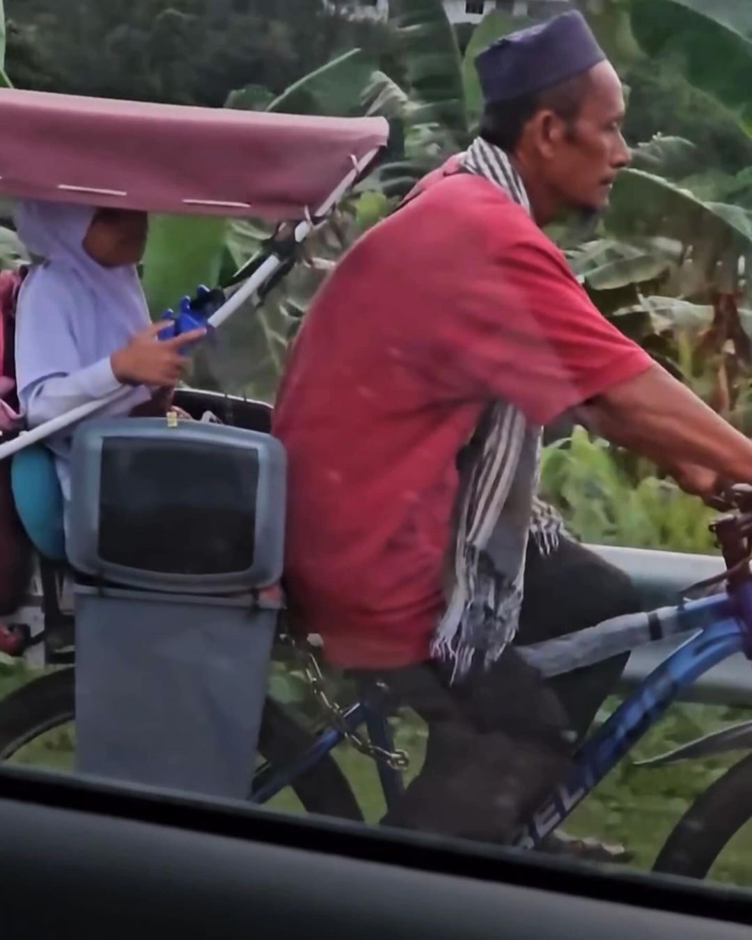 Man using bicycle to pick up his kid