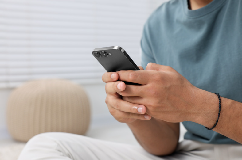 Man using phone to send email