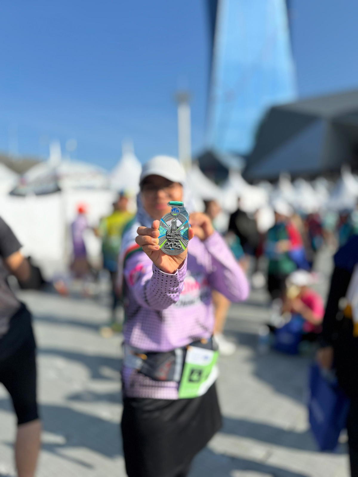 Mazwin showing medal of a marathon