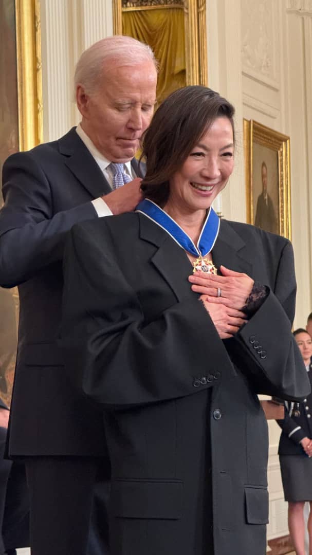 Michelle yeoh receiving medal from us president