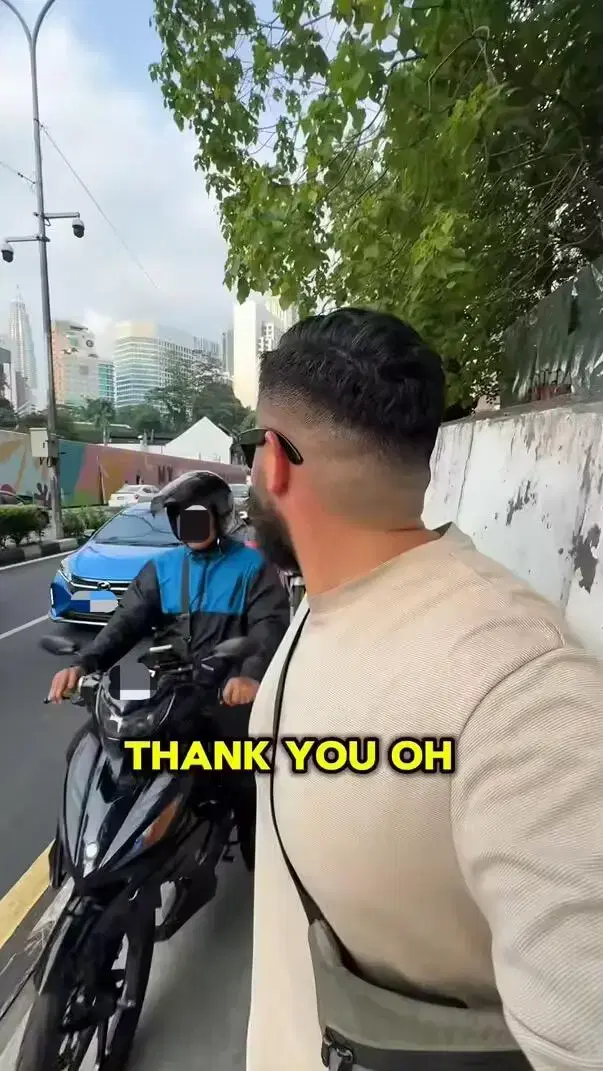 Motorcyclist drives past Chris along pedestrian walkway