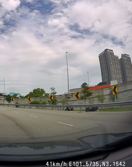 Motorcyclist lying on the gorund after being crashed