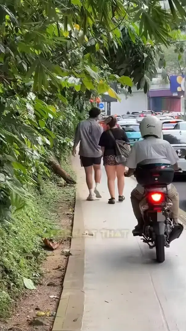 Motorcyclist using same walkway as pedestrian in KL