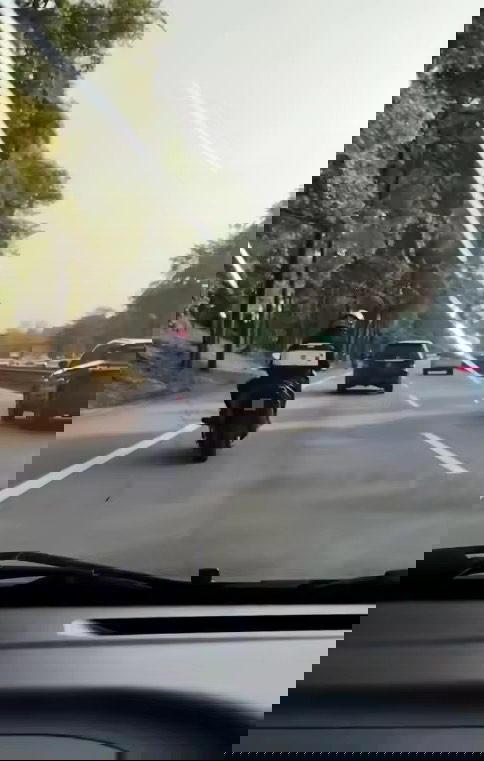 Motoryclist throws rock at car 1