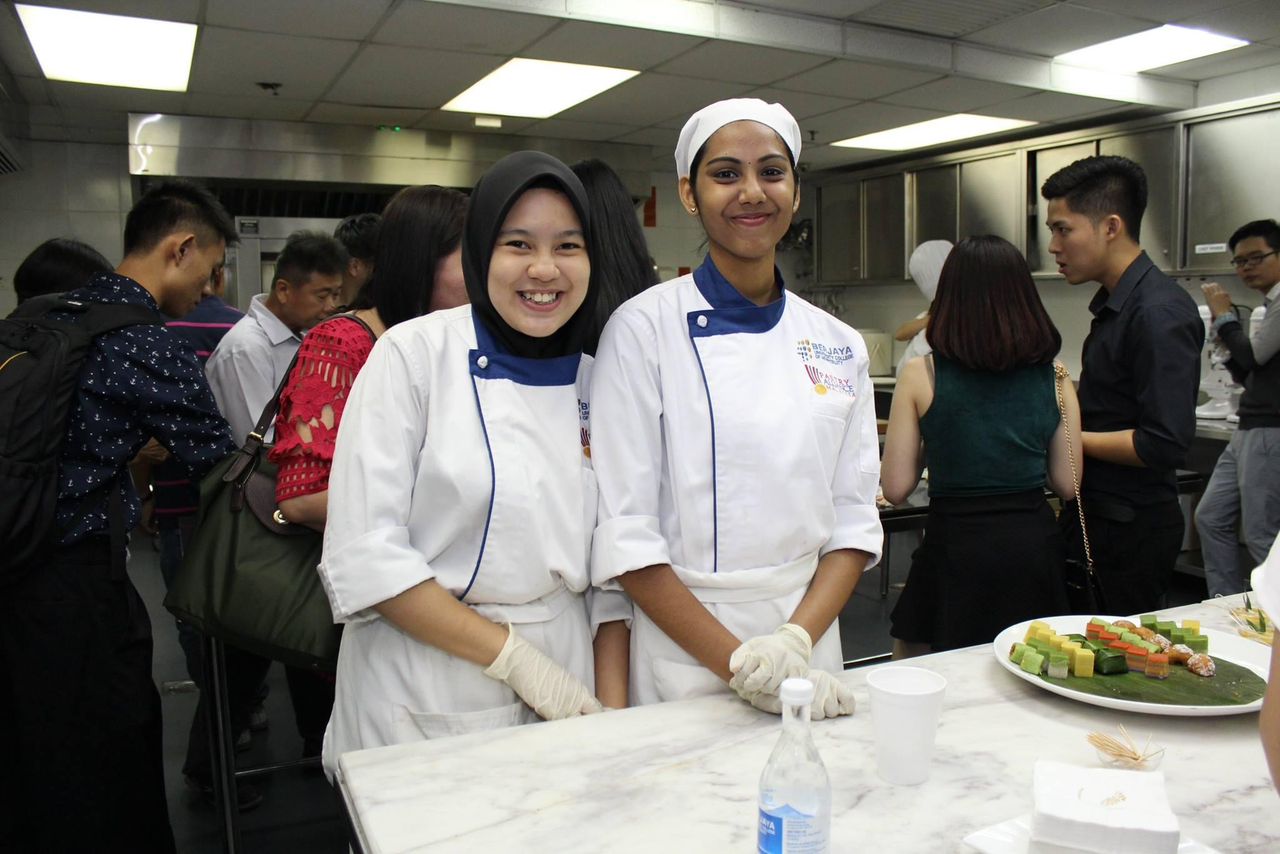 Msian chef graduates standing at teh kitchen