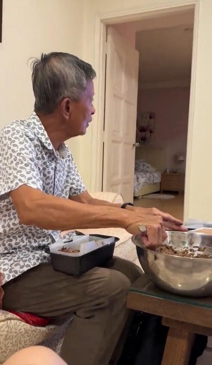 Msian dad putting the batter inside the baking bowl