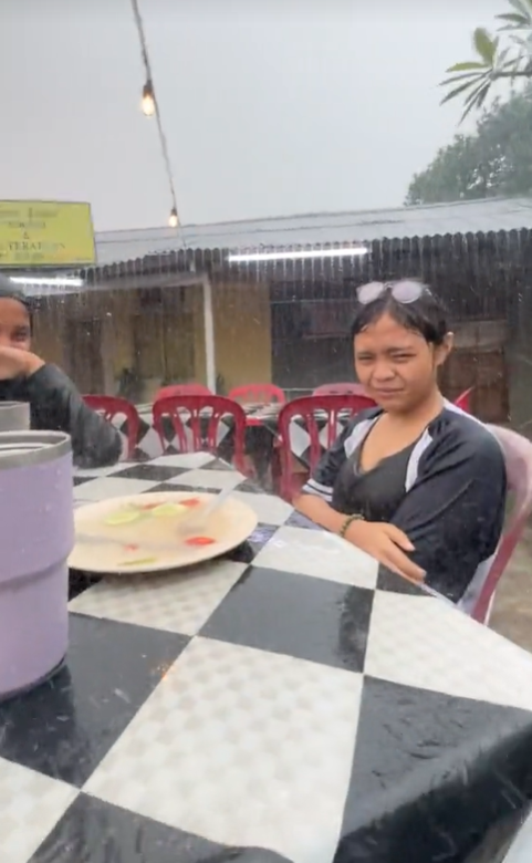 M'sian girl gets soaked while sitting in the rain