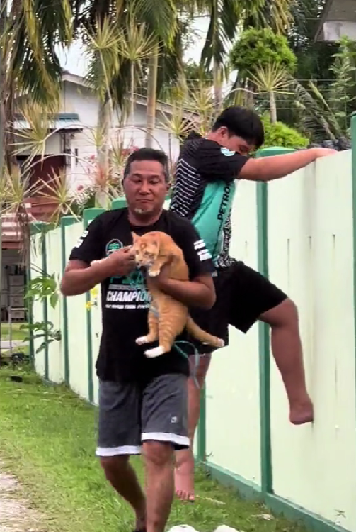 Msian holding a cat