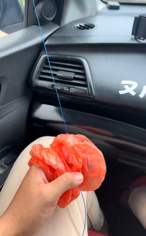 M'sian man holding a string to move windscreen wiper