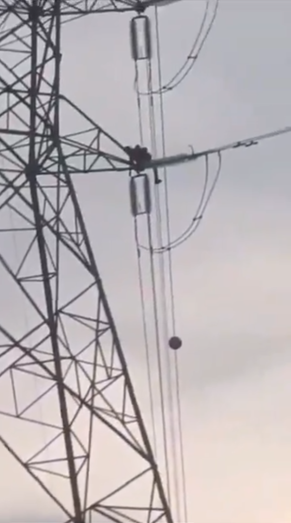 M'sian man on top of transmission tower