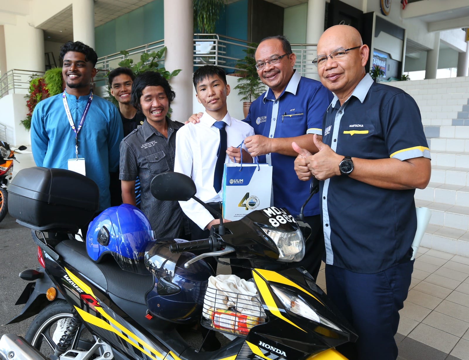 M'sian man rides motorbike to uum to accompany brother