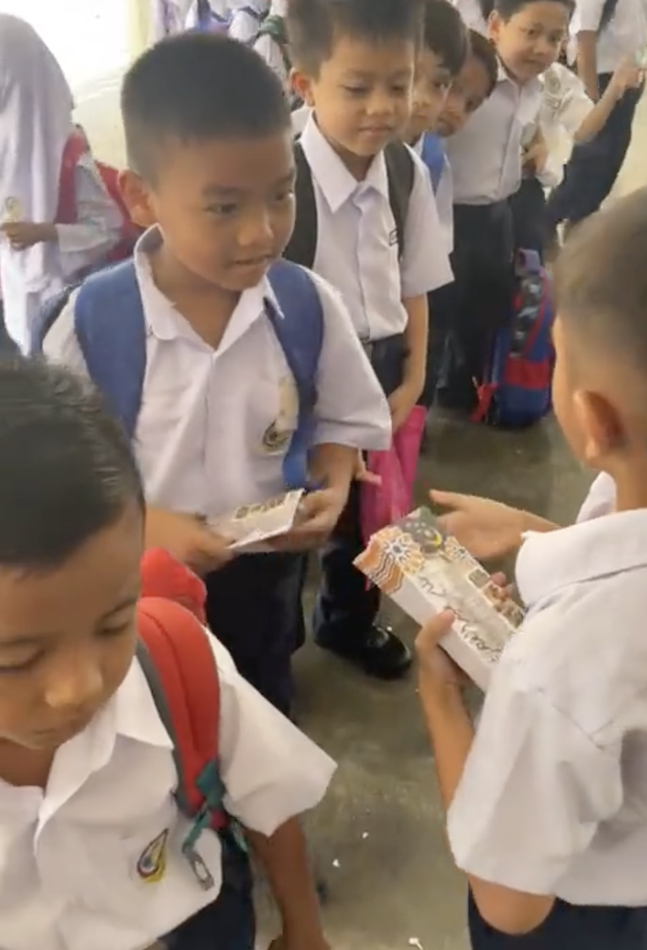 M'sian primary school boy gives out 'duit raya' to his classmates  3
