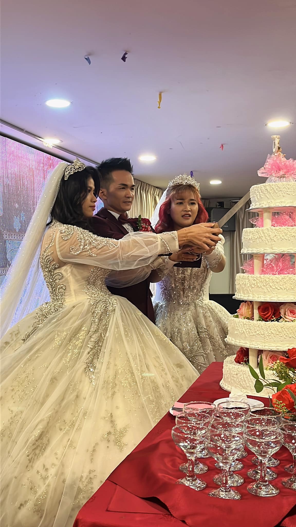 Sarawak man cuts wedding cake with his 2 wives