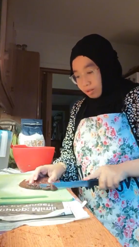 Msian woman cutting whale meat