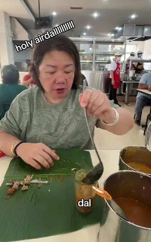 msian woman pouring dhal in the cup