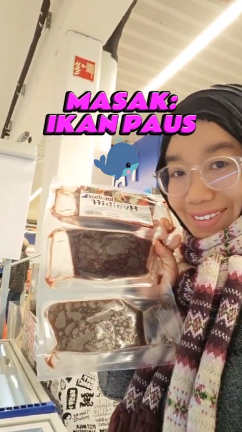 Msian woman showing a pack of whale meat in a grocery meat