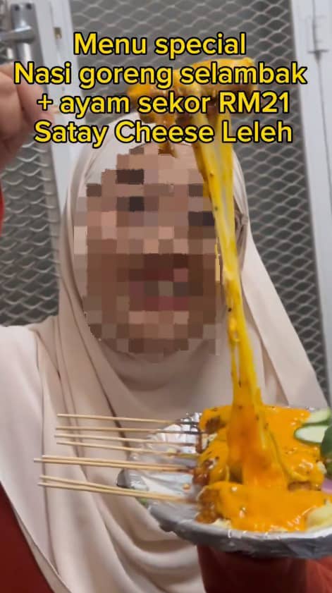 Msian woman showing cheese satay